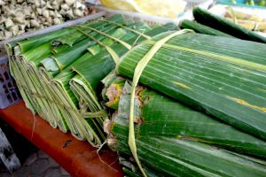 packs of banana leaves cut on rectangular shape sold on the market in Bali island, Indonesia