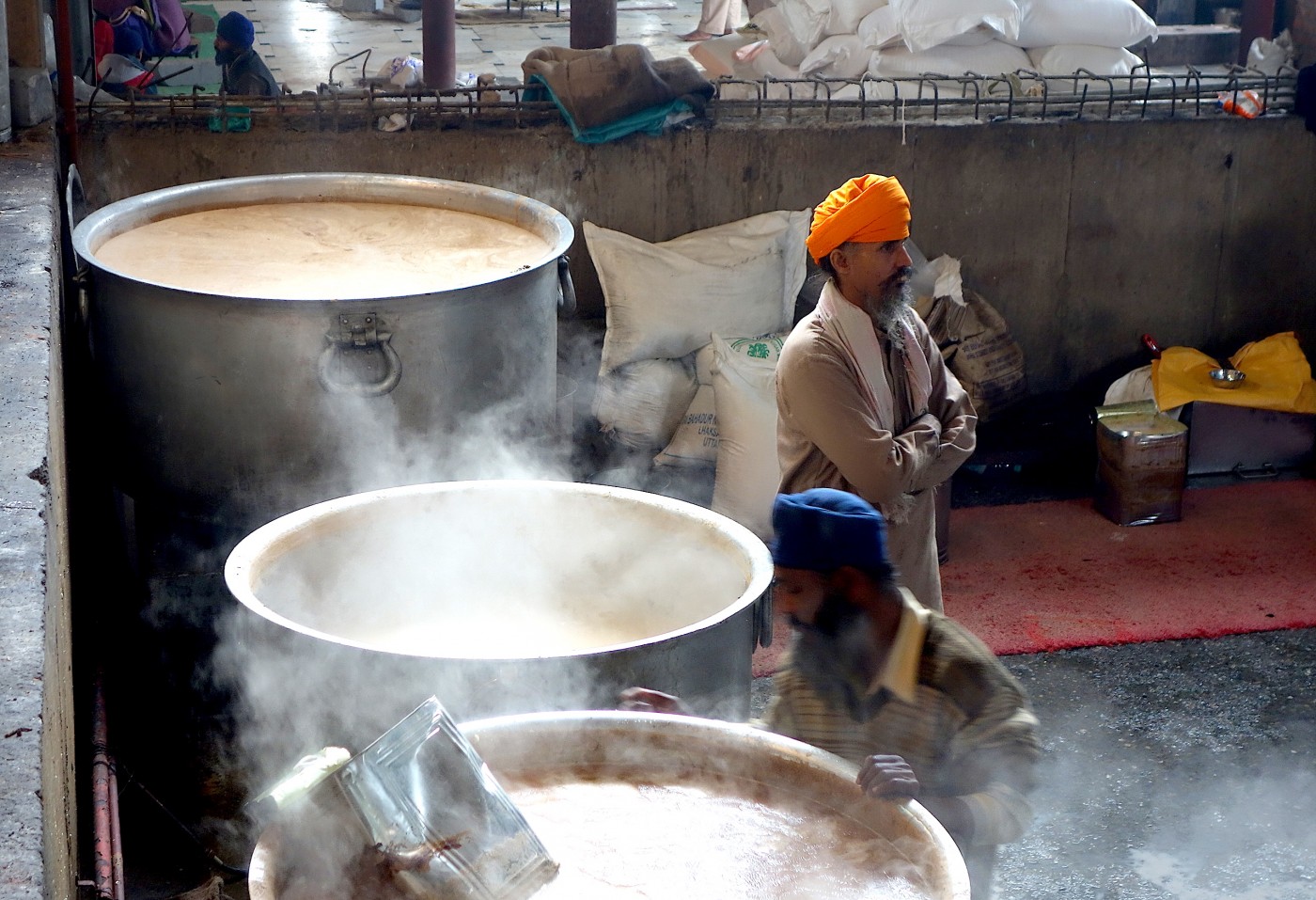 A cook in the Golden Temple cooks in an extremely large pot
