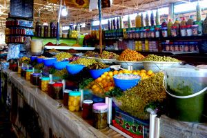 Shop with olives and salt preserved lemons on traditional market in Morocco by Authentic World Food