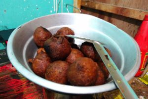 Bonda after removing from wok - banana balls with cardamon in a street restaurant in Kerala, India - by Authentic World Food