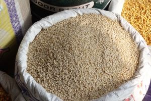 white lentils - urad dal sold in bags in New Delhi spice market, India