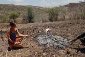 Bo on the road making roasted chicken Lombok style in a rural are, Indonesia