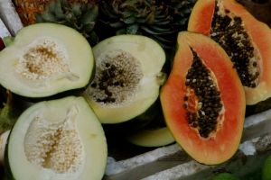 green and ripe papaya cut on halves on traditional Vietnam market