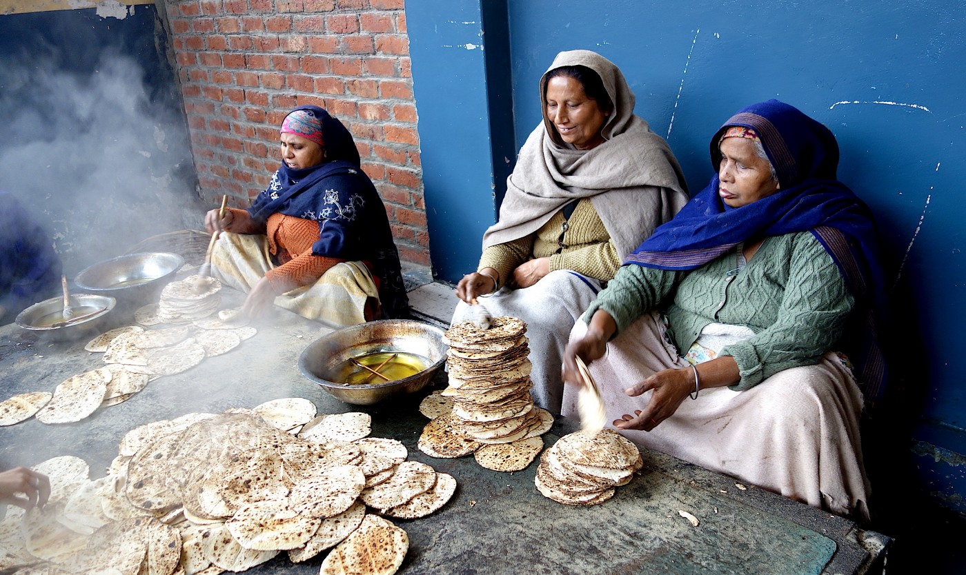 A cook in the Golden Temple cooks in an extremely large pot