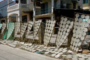 drying rice paper on the street in front of a family rice paper factory