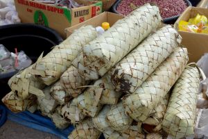 palm sugar in coconut leaves sold on market in Lombok island, Indonesia