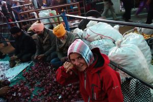 Bo on the road peeling onions in community kitchen, Golden temple, Amritsar, India