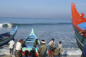 surfing in a colorful fishing village, Kerala, India