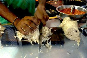 Noodle cutting for kottu roti in Sri Lanka - by Authentic World Food