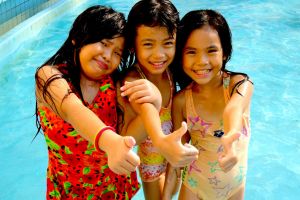 friendly Vietnamese girls in a swimming pool in Saigon, Vietnam - by Authentic World Food