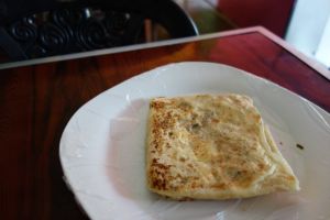 egg roti served on a plate in a small Sri Lankan restaurant