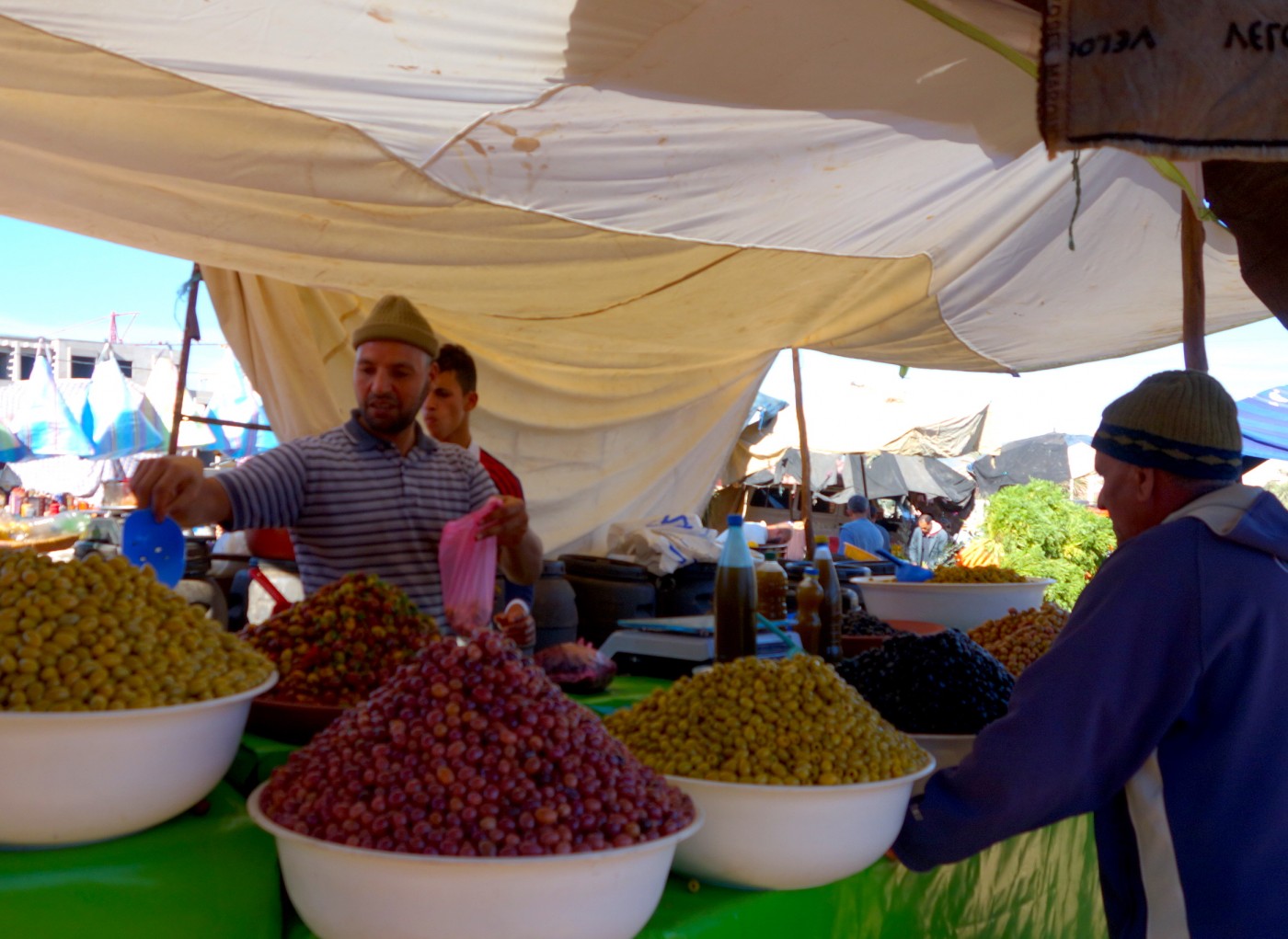 Olive vendor on traditional market souk in Morocco