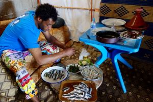 Omar preparing sardines with herbs. Authentic recipe from Morocco.
